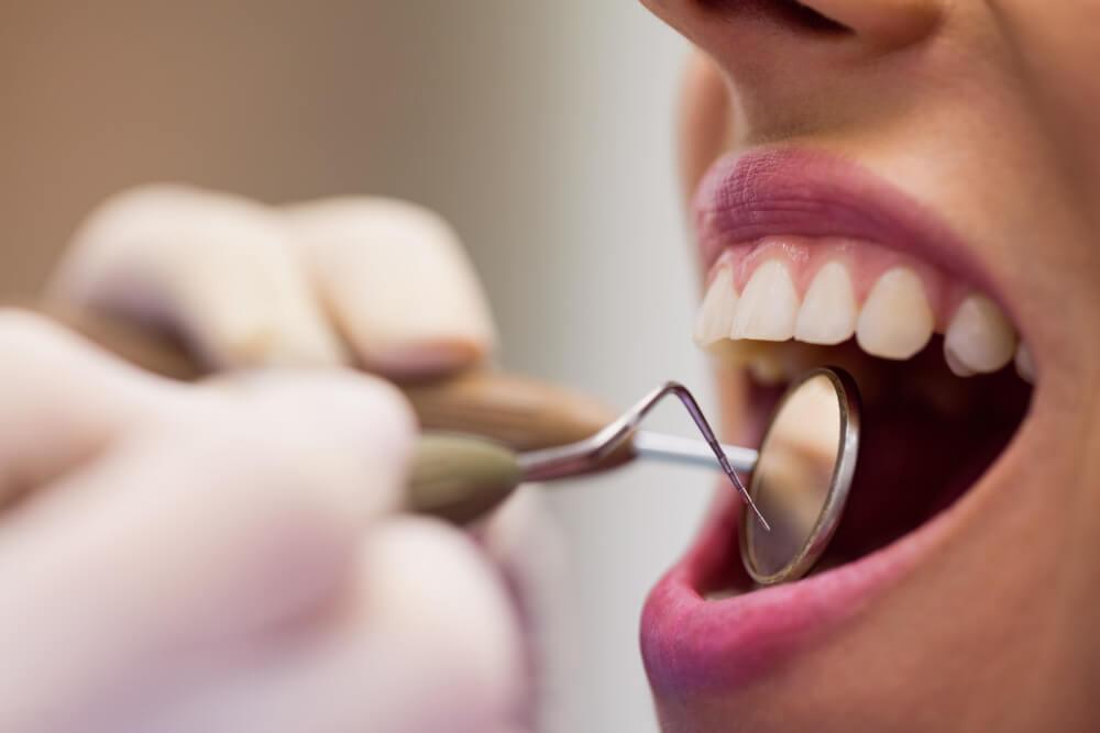 a dentist examining a patient's teeth