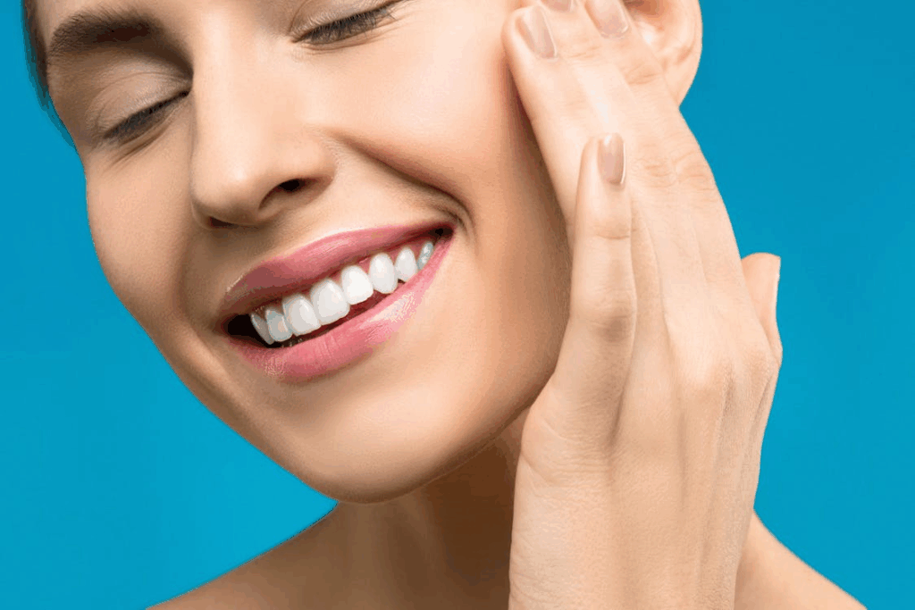 a close-up picture of a woman showing her pearl white teeth